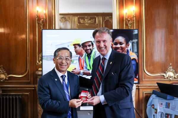 Ir Thomas Ho Chairman of CIC is presented with a City of London Police commemorative coin by David Clarke